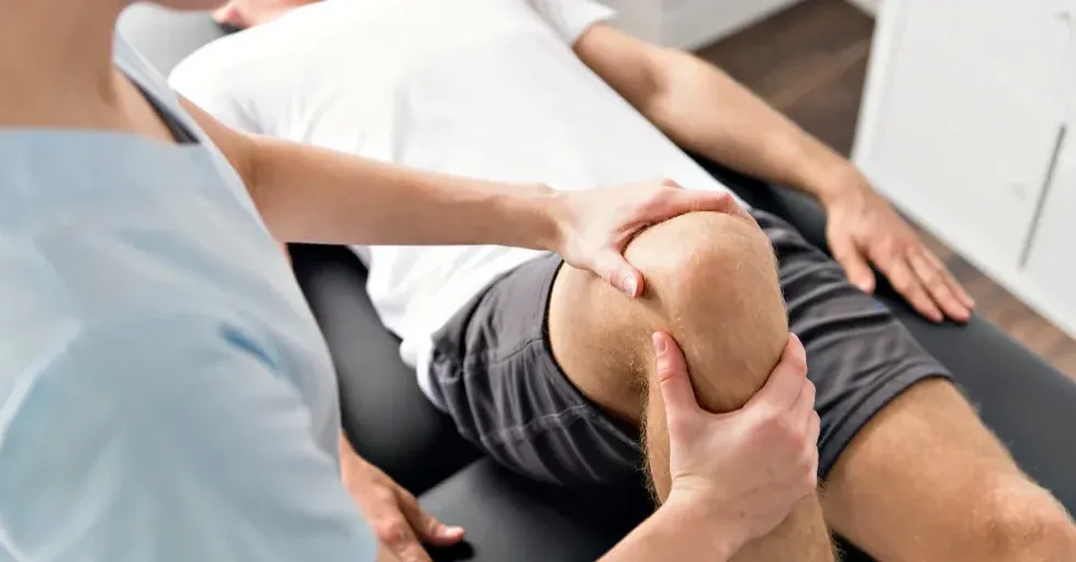 Physical therapy patient with knee and hip treatment.